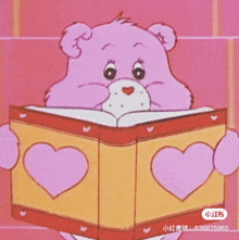 a care bear is holding a book with hearts on it