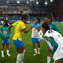 a group of female soccer players on a field with one wearing a shirt that says ' guarana ' on it