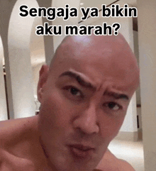 a bald man with the words sengaja ya bikin aku marah written on his head