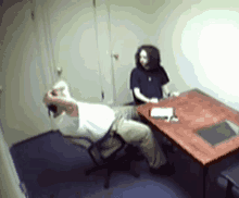 a blurry picture of two men sitting at a desk