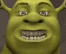 a close up of shrek 's face with his eyes closed and his mouth open .