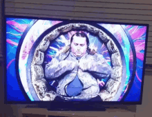 a man is sitting in a circle on a television