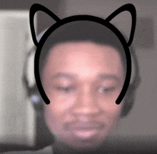 a man wearing headphones and a headband with cat ears on it