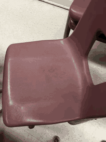 a red chair with a stain on the seat