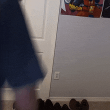 a dragon ball poster hangs on a wall next to a pair of shoes