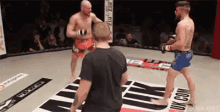 two men are fighting in a boxing ring with a sign that says uk.com on it