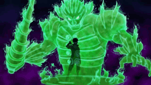 a silhouette of a person standing in front of a large green monster