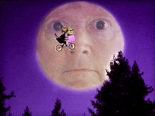 a person riding a bike in front of a large moon