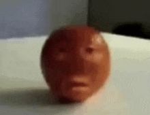 a close up of a red egg with a face on it .