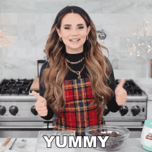 a woman giving a thumbs up next to a bowl of chocolate chips with the word yummy written on it