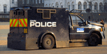 a black police vehicle is parked on the street