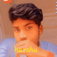 a close up of a young man 's face with the name harshu written in yellow