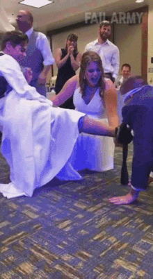 a bride and groom are dancing at a wedding reception with the words fail army on the wall behind them