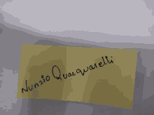 a yellow piece of paper that says nunzio quaquarelli on it