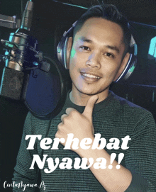 a man wearing headphones giving a thumbs up in front of a microphone with the words terhebat nyawa written below him