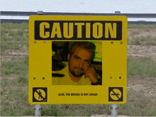 a caution sign with a picture of a man