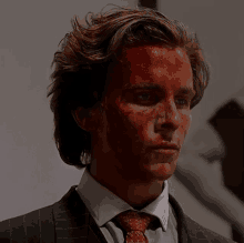 a man in a suit has blood on his face