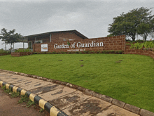 a sign that says garden of guardian in front of a house