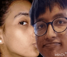 a woman kissing a man 's cheek in a video that says inshot on the bottom