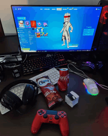 a desk with a computer monitor headphones chips and a can of coca-cola