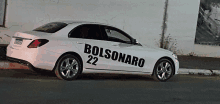 a white car with bolsonaro 22 written on the side of it