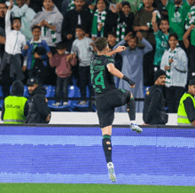 a soccer player with the number 14 on the back of his shirt