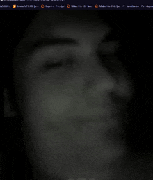 a blurred image of a person 's face with a few letters visible