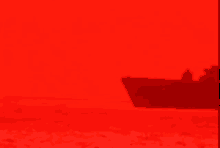 a red background with a shadow of a boat in the water