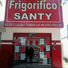 a red and white store front with a sign that says frigorifico santy on it .