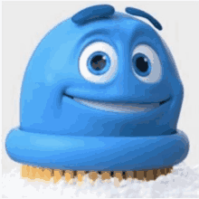 a blue cartoon character with a smile on its face is sitting on a brush .