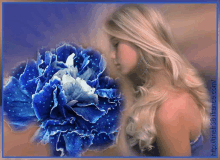 a woman in a blue dress is holding a large blue flower in front of her face