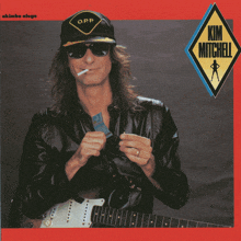 a man wearing sunglasses and a hat with the name kim mitchell written on it