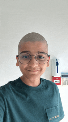 a boy wearing glasses and a shirt that says boats on the pocket