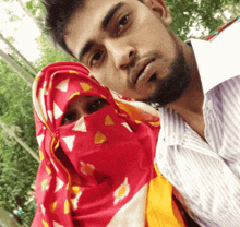 a man and woman are posing for a picture with the woman covering her face