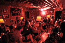 a crowd of people are gathered in a dark room