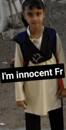 a little girl with a backpack stands in front of a sign that says " i 'm innocent fr "