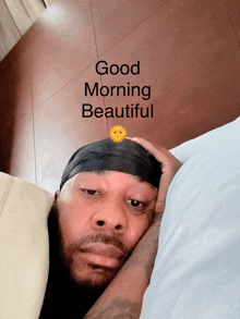 a man is laying in bed with the words good morning beautiful written above him