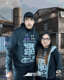 a man and a woman are posing for a photo in front of a building that has the word union on it