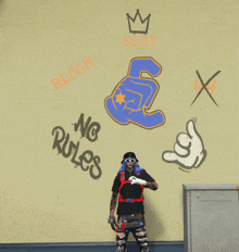 a man is standing in front of a wall that has graffiti on it including the words no rules