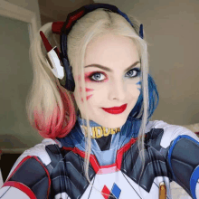 a woman in a harley quinn costume is smiling