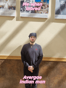 a man stands in front of a wall with a poster that says me when inbred