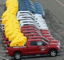 a row of tundra trucks are lined up in a parking lot