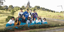 a group of young people posing for a picture with one wearing a shirt that says ' ucsd ' on it