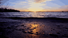 a sunset over a body of water with the words living stills on the bottom right