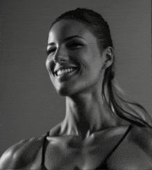 a black and white photo of a smiling woman