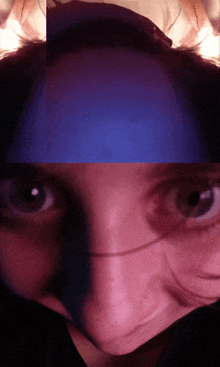 a blurry picture of a person 's face with a blue background