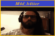 a picture of a man with a beard wearing headphones with the name m4d_h4tter on the bottom