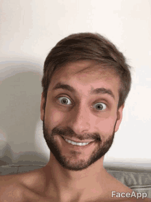 a shirtless man with a beard is smiling for the camera with faceapp written below him