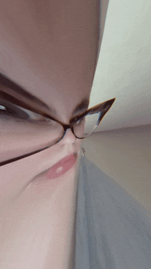 a blurry picture of a woman wearing glasses and making a face