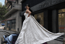 a woman in a white dress is standing in front of a building that says pons